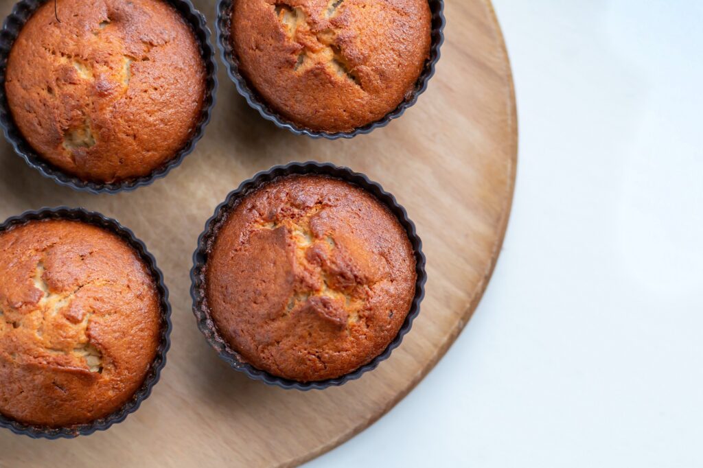 Four muffins on a plate