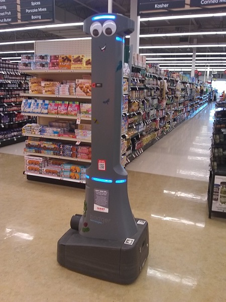 A tall robot in a grocery store